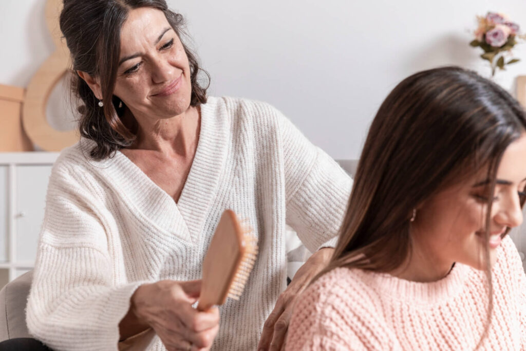 women with different ages combing hair